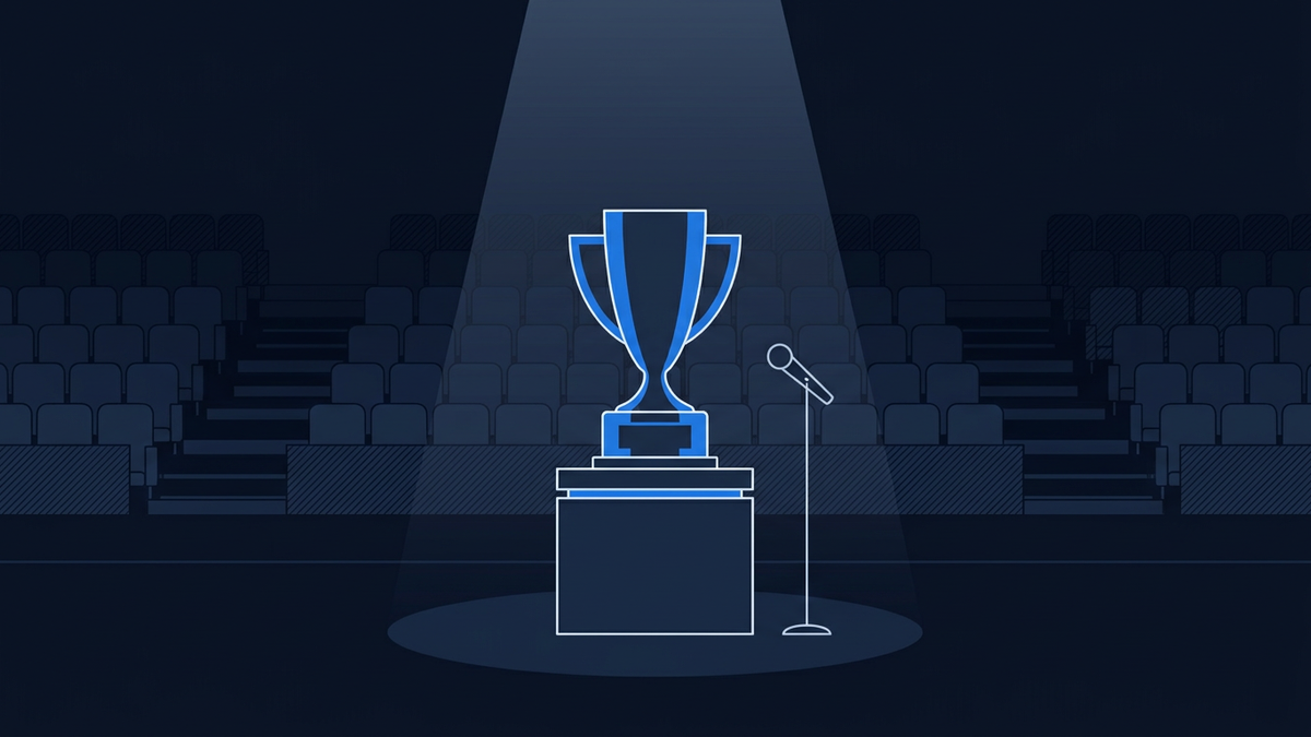 An empty awards-show stage bathed in soft light, a lone trophy silhouette centred on a plinth, with tiered seating fading into darkness behind it.