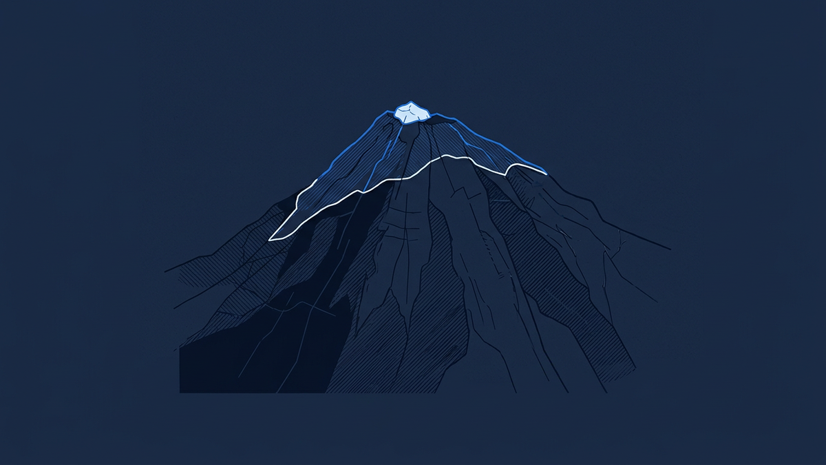 A solitary fragment of tropical mountain ice perched on a dark equatorial peak, dwarfed by the surrounding rock face it once covered.