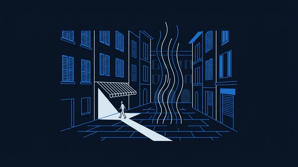 A stylised blue line-art city street at night shows a lone figure walking through a beam of light from a shop awning, with wavy white lines rising from the cobblestones, surrounded by multi-storey buildings with shuttered windows.