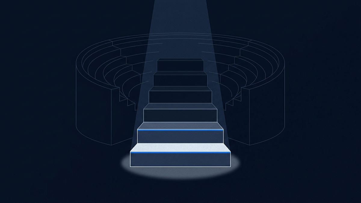 A tiered staircase of six ascending platforms with a single spotlight falling on the lowest, widest step, an empty amphitheatre curving behind.