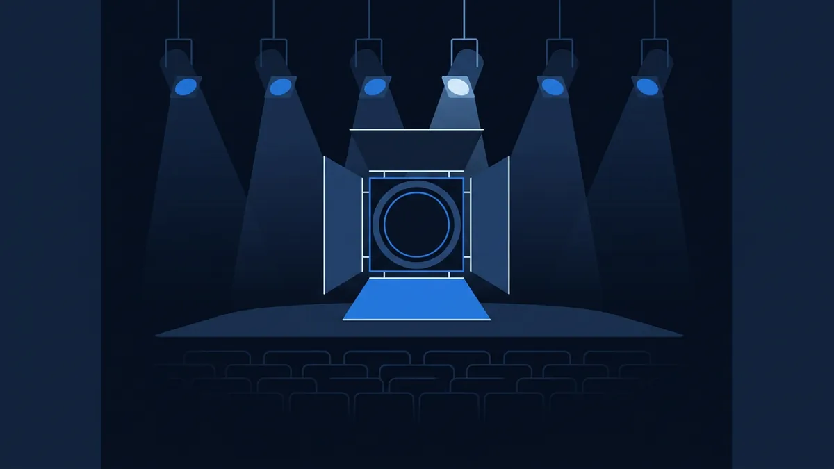 A flat vector illustration of an empty theatre stage lit by six hanging blue spotlights, with rows of dark auditorium seats in the foreground and a framed circular portal or screen centred on the stage, all in a deep navy and blue palette.