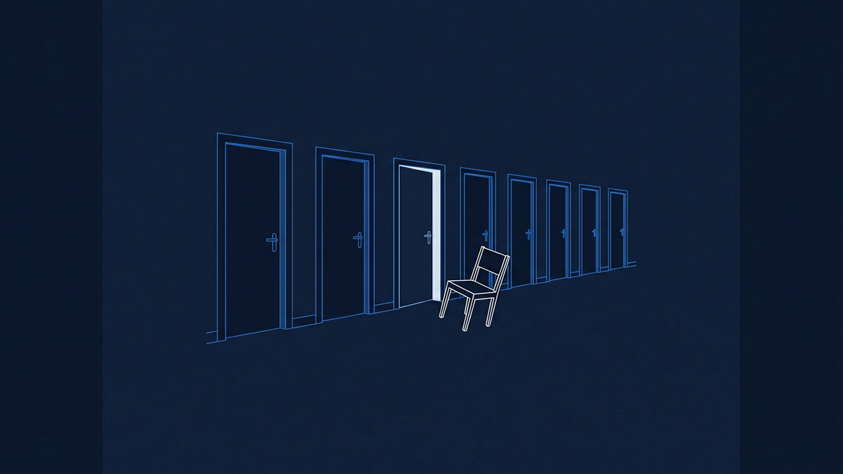A row of empty office chairs in a corridor of doors, one chair tipped slightly away from the rest, suggesting departure