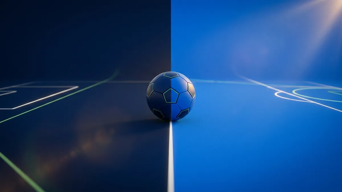 A blue soccer ball sits on a white centre line of an indoor futsal court, split between a dark navy left half and a bright electric-blue right half, with green court markings visible and a lens flare in the upper right.