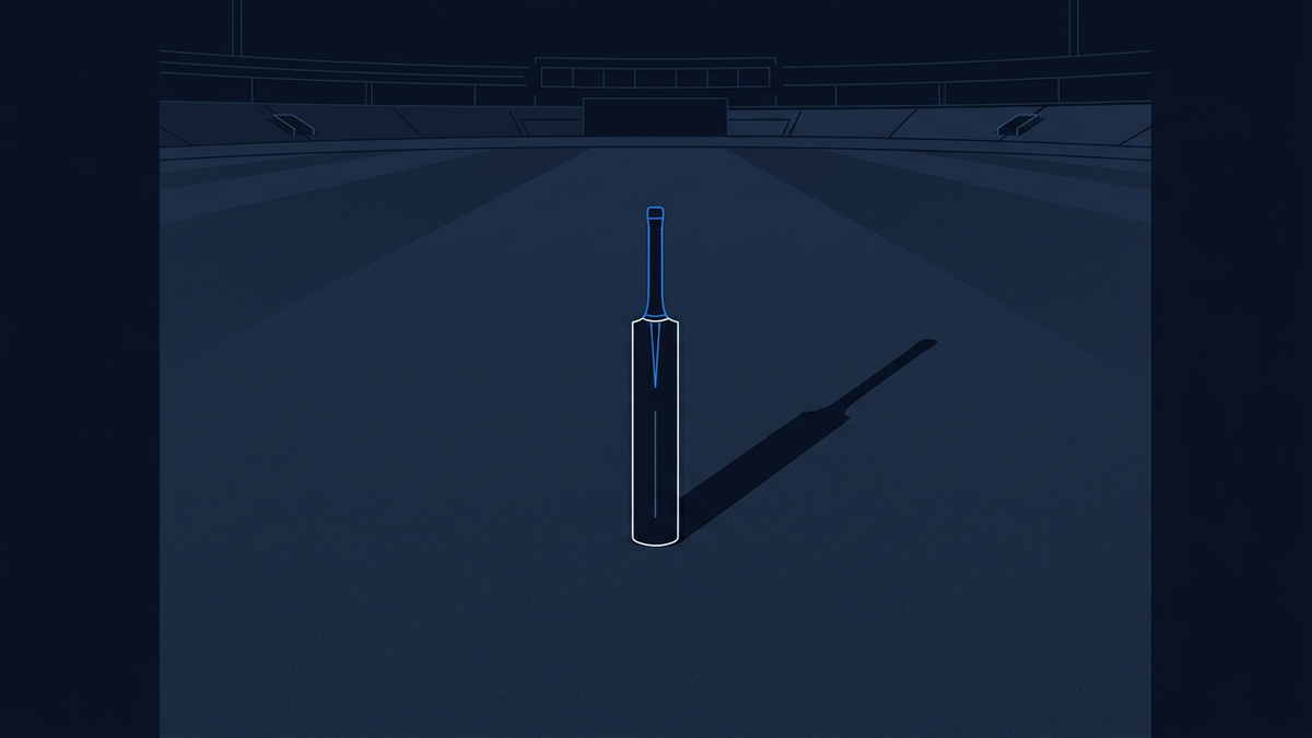 A solitary cricket bat propped upright in the centre of an empty floodlit stadium, long shadows trailing behind it across the outfield