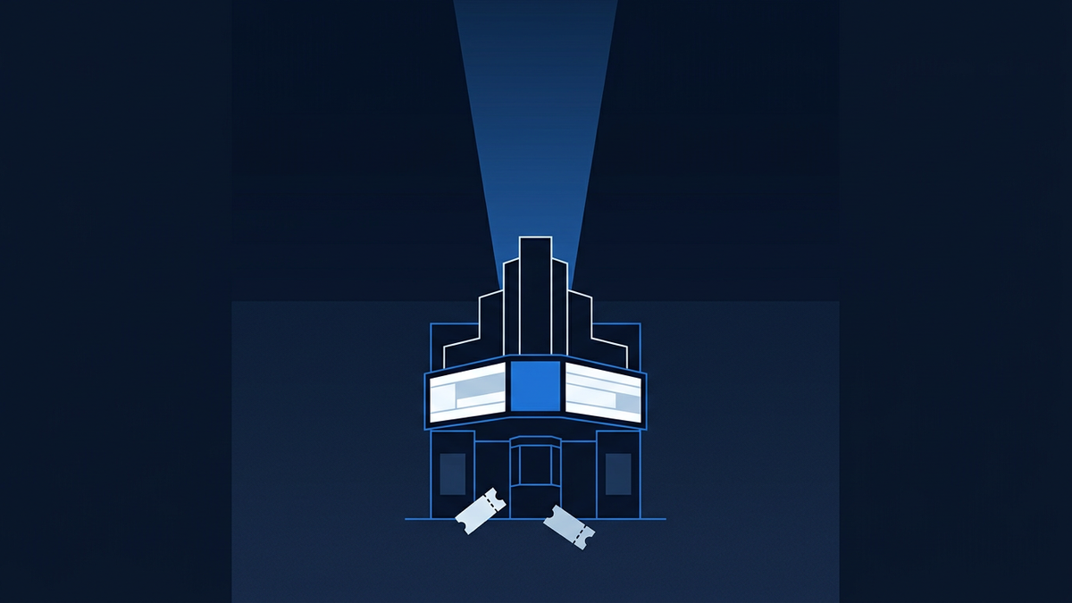 A cinema marquee silhouette towering against an empty night sky, with a single spotlight beam cutting upward through the centre of the frame